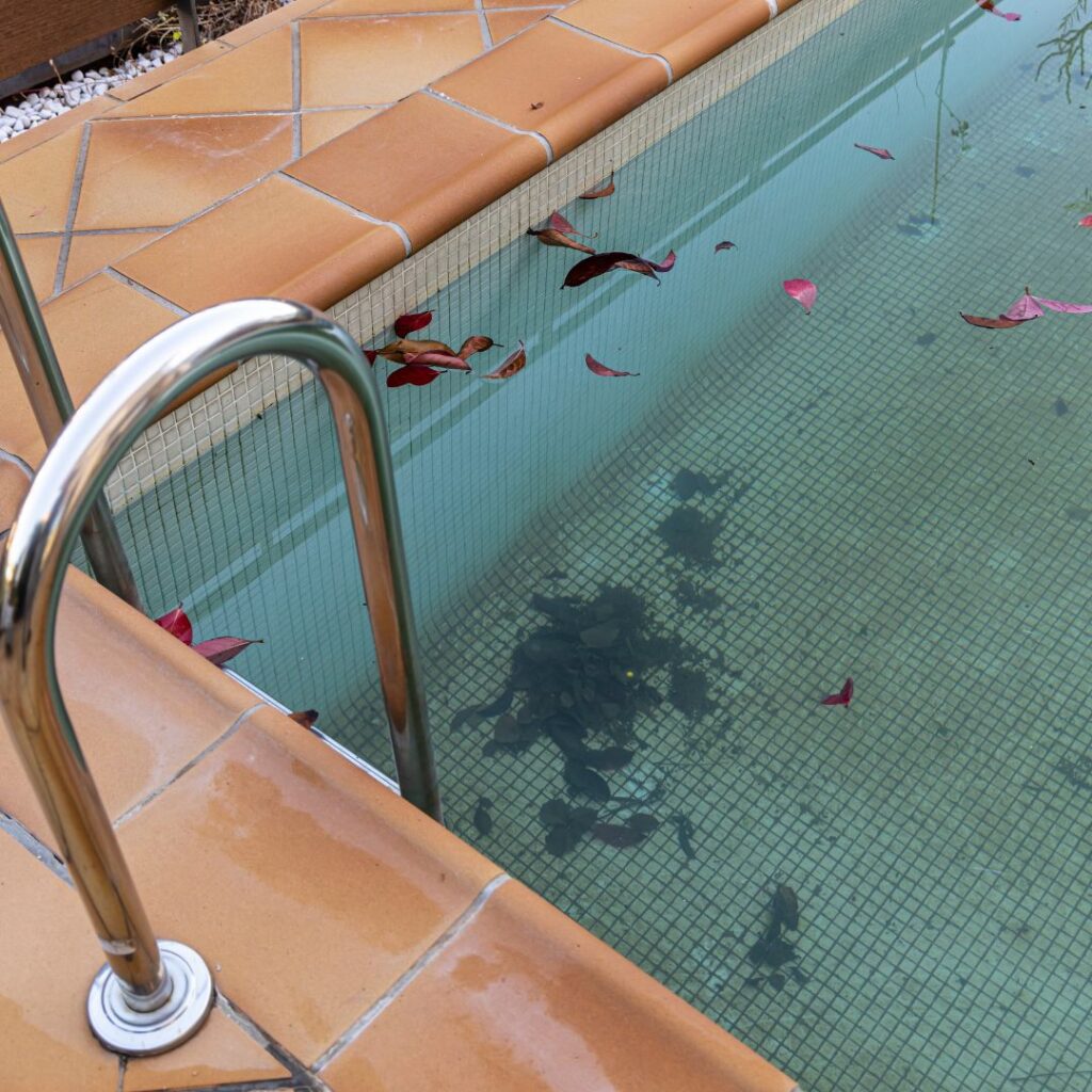 debris covering pool floor and walls