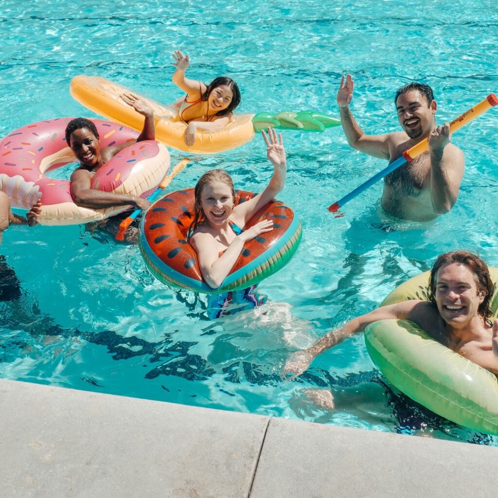 Kids in tubes swimming in a pool
