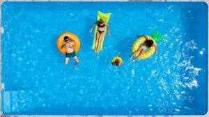 Family on pool floaties in pool
