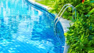 Swimming pool ladder near bushes