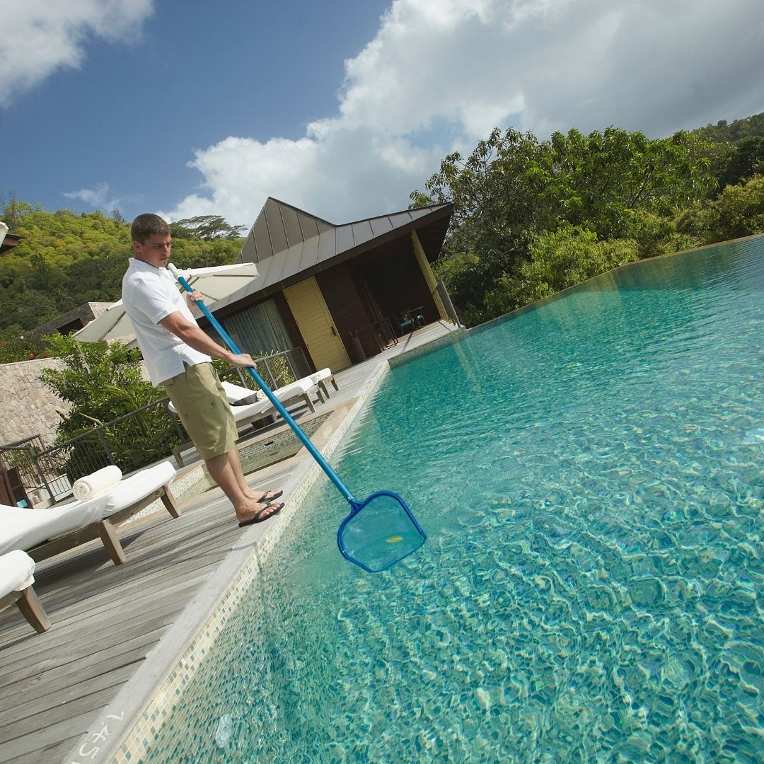 person cleaning a pool
